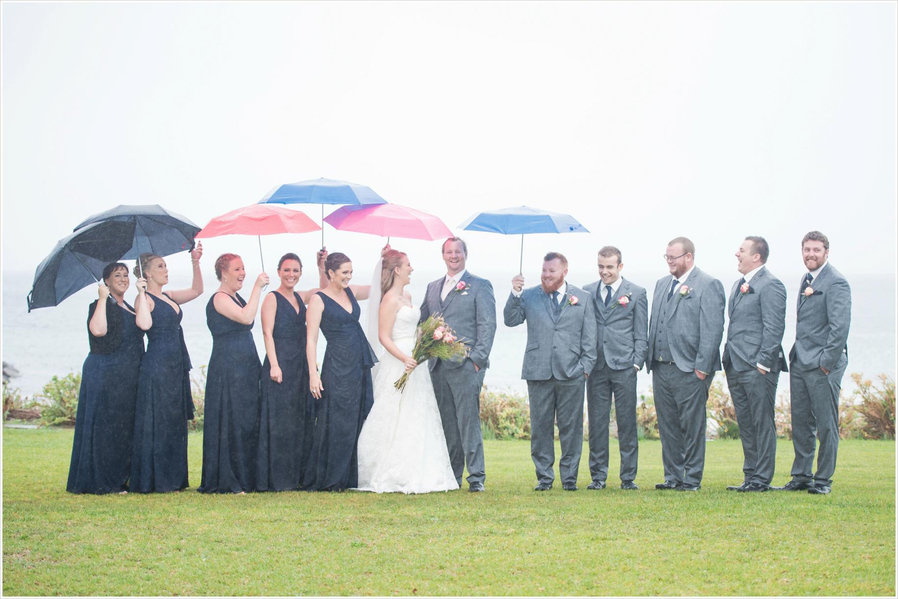 bridal part in the rain with umbrellas