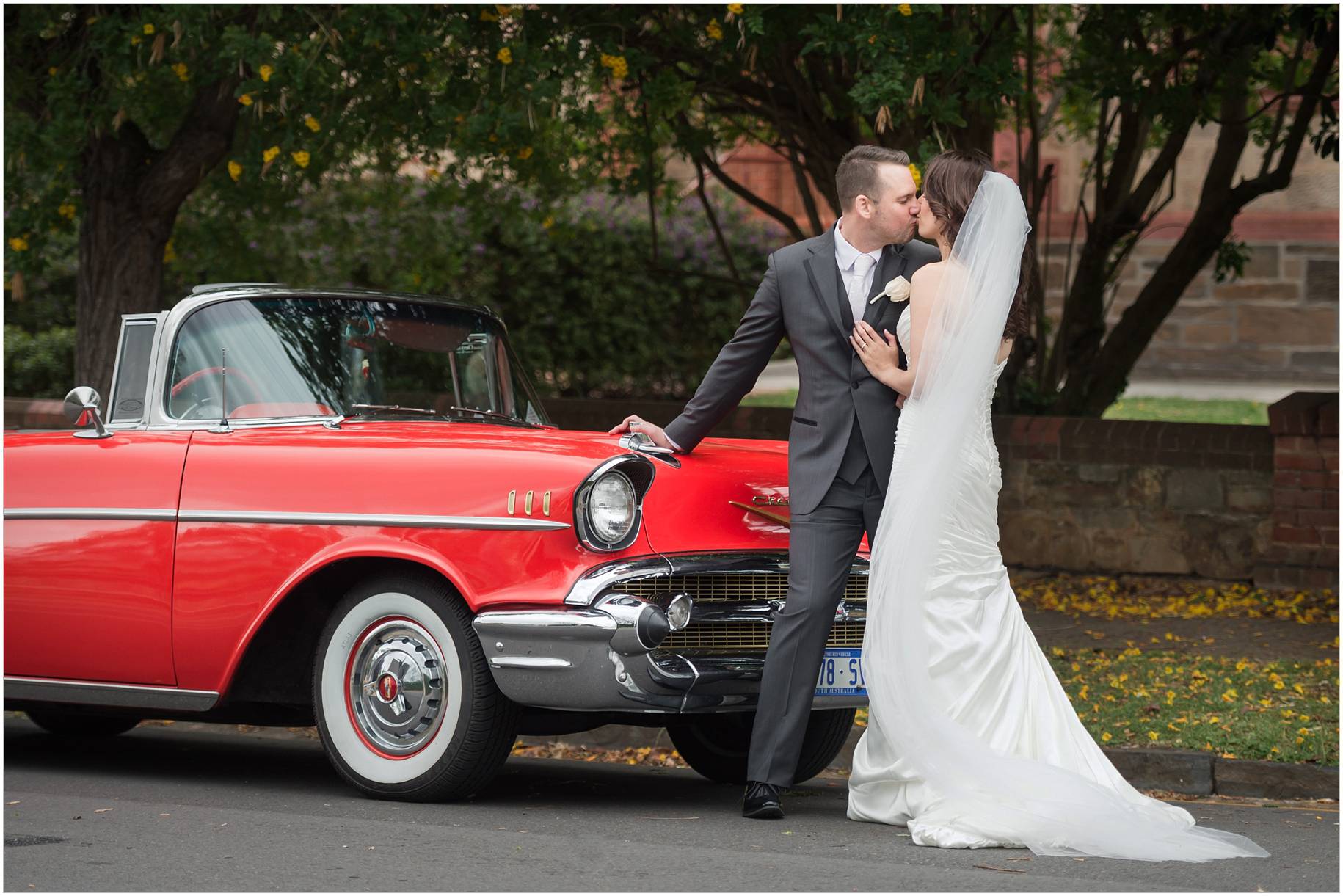 bride and groom and car